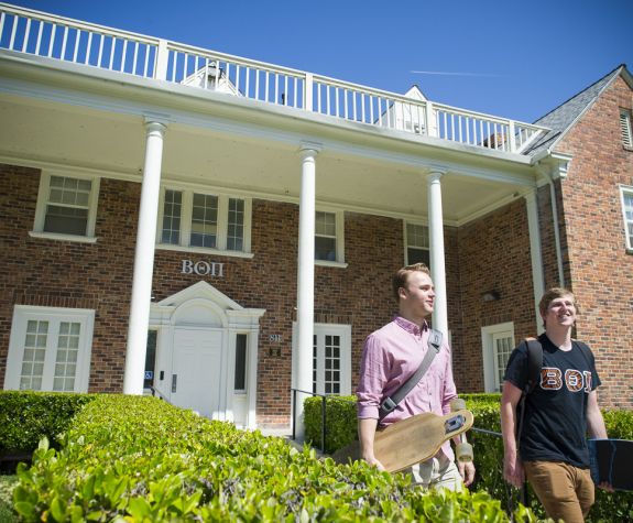 Members of Beta Theta Pi outside fraternity house