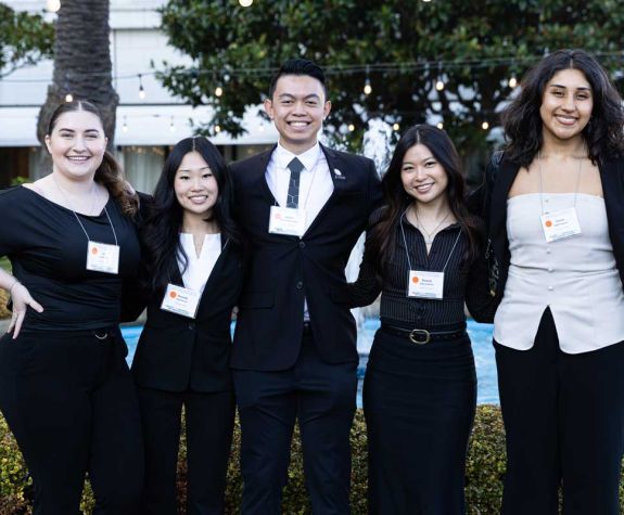 Group of Annual Meeting attendees posing outside