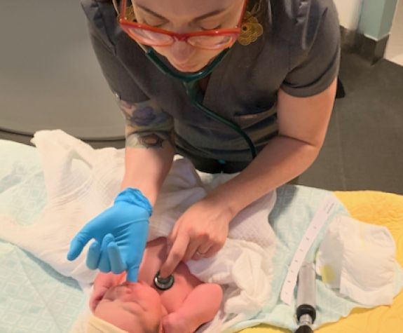 a midwife with a tiny baby