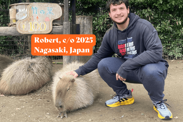 boy next to a capybara