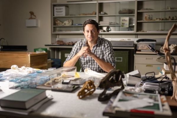 Chris Torres sits at his desk