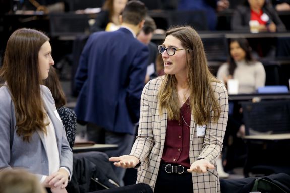 Students speaking with each other.