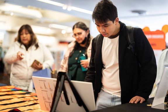 Students purchasing regalia at the bookstore