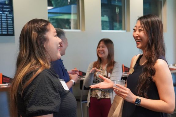 Two alumni speaking at the Stockton reception 