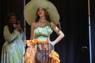 a student poses in the fashion show