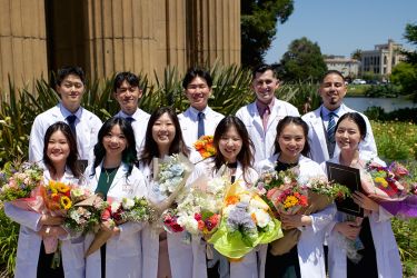 six women and five men wearing their white lab coats