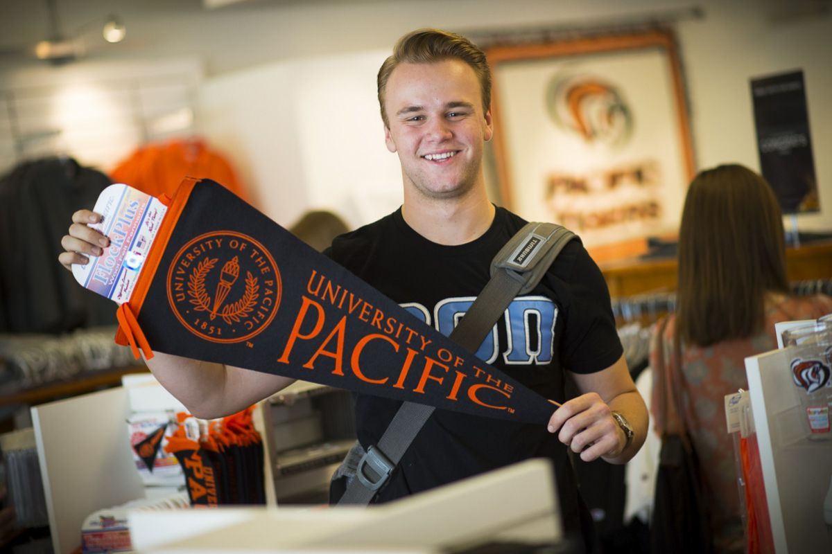 guy holding pennant 