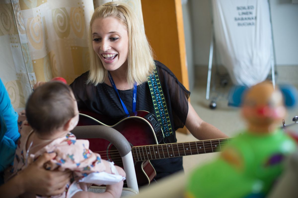 University of the Pacific MA in Music Therapy student Kathleen Humphries works with young patient during field visit.