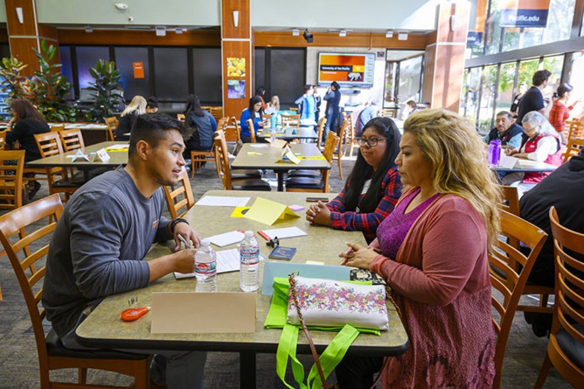 Students working the annual immigration fair.