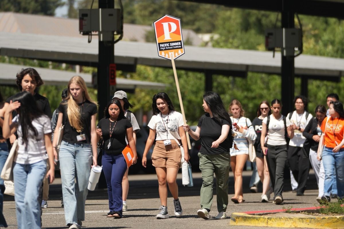 summer high school institute students walk across a parking lot