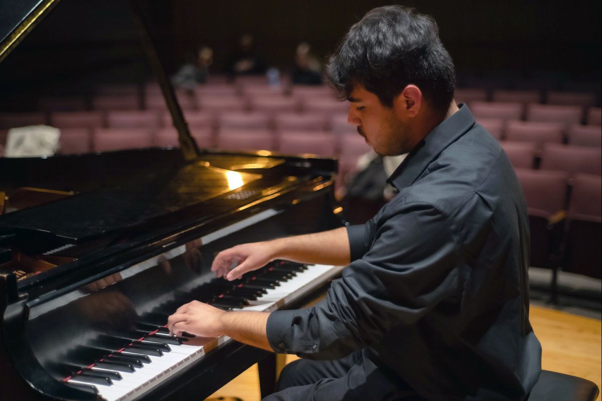 A student pianist performing on stage