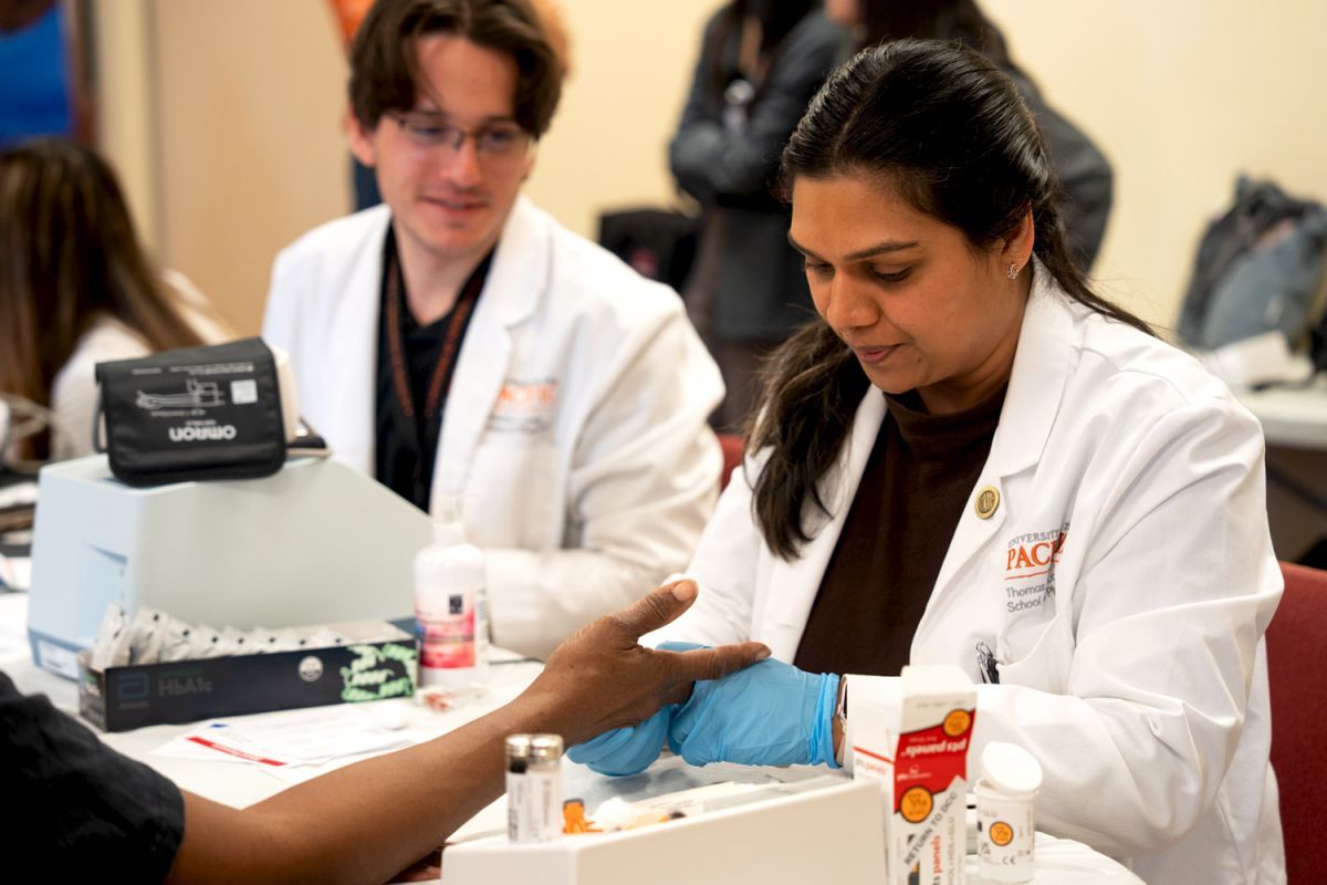 Doctor of pharmacy student with patient at diabetes clinic