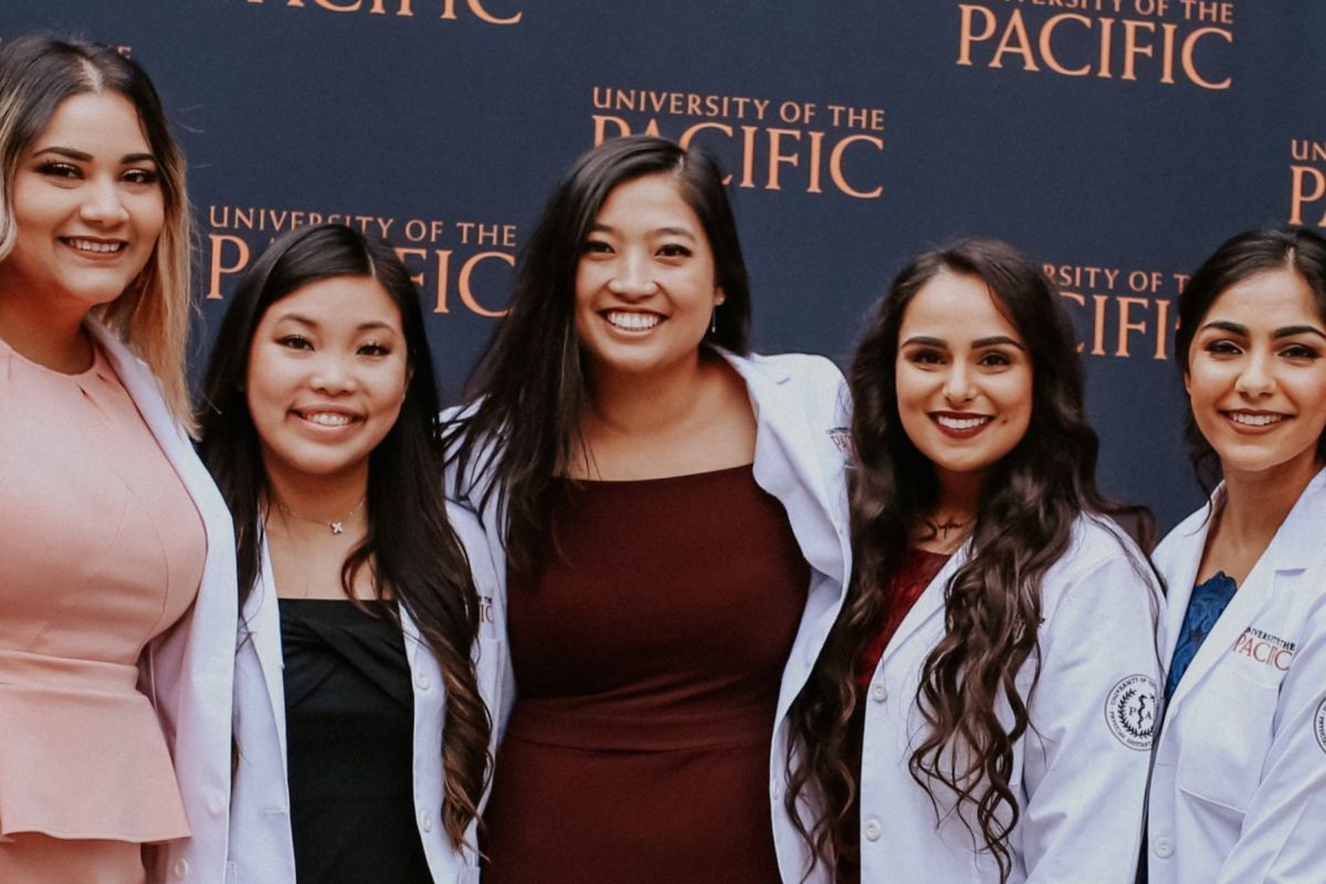 Photo show the smiling faces of seven PA students at UOP.