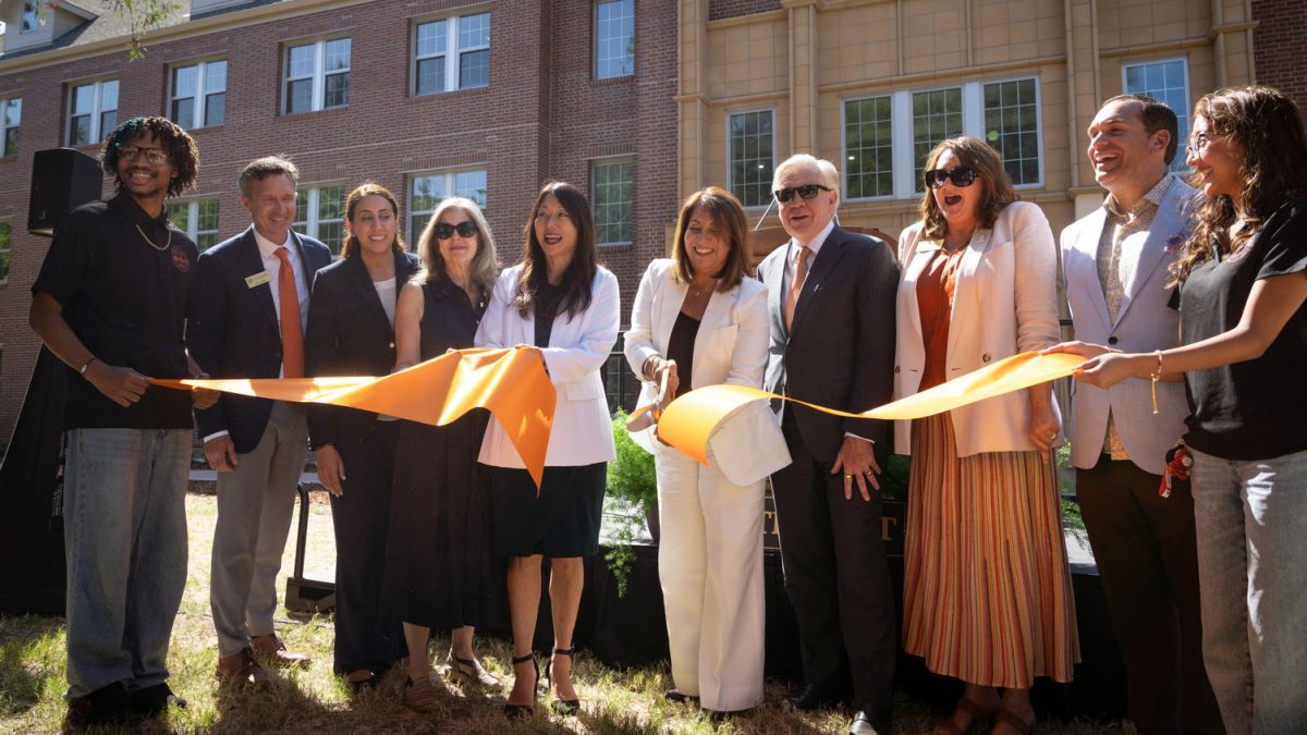 University and state leader cut an orange ribbon outside of Southwest Hall