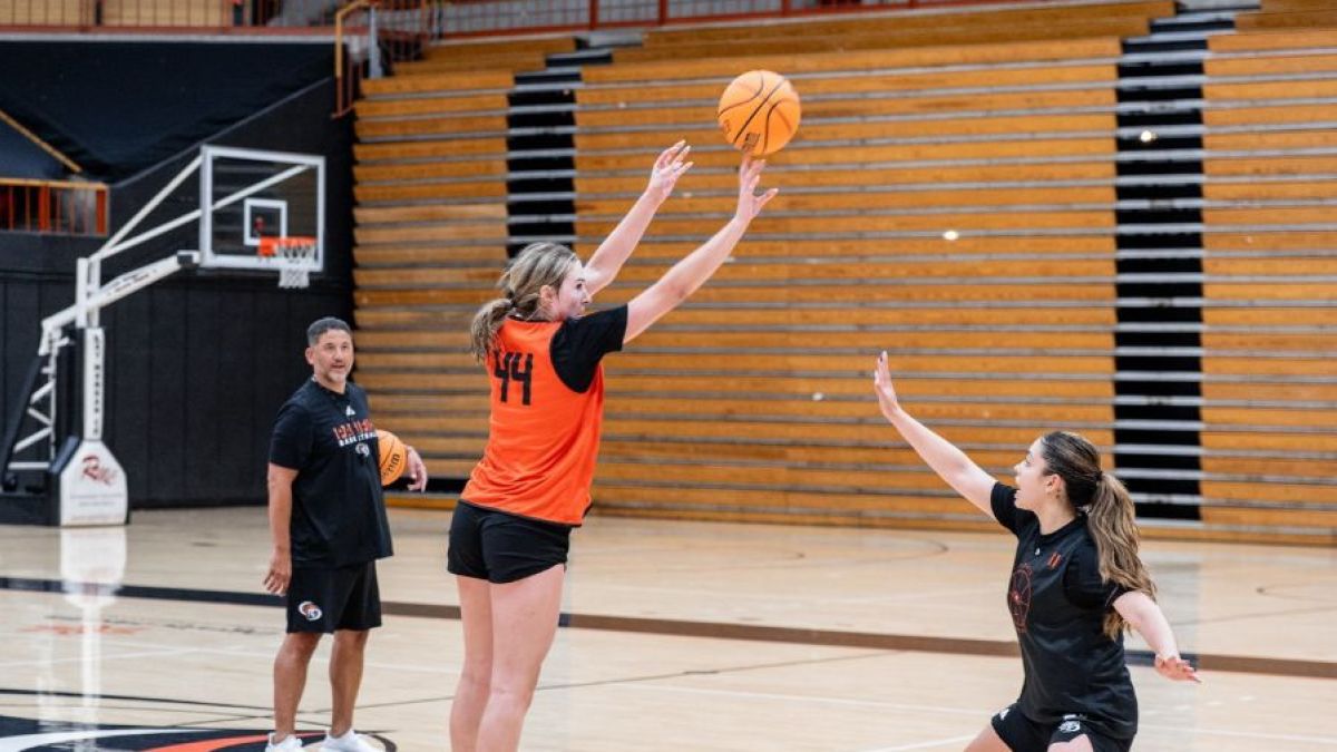 A student shoots a basketball 