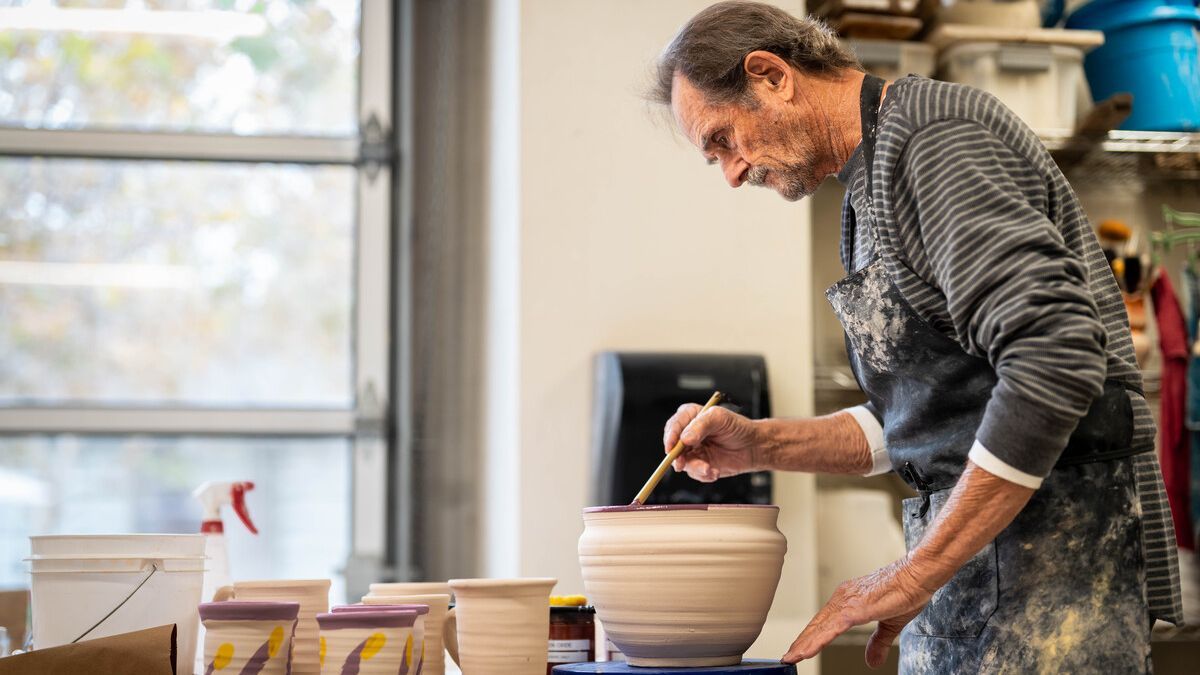 A man paints pottery