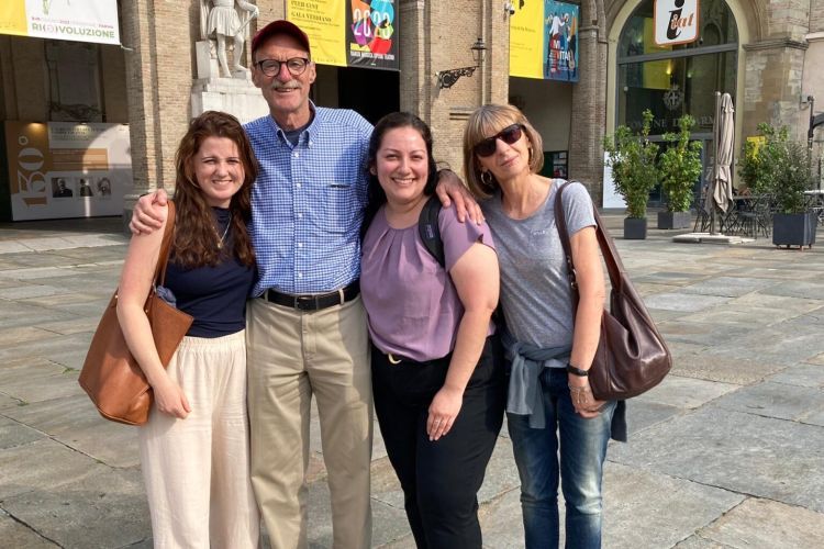 A group of four people pose for a photo in Italy