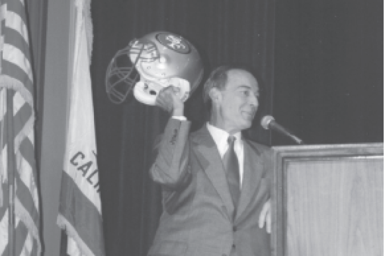Don DeRosa holds up at 49ers helmet