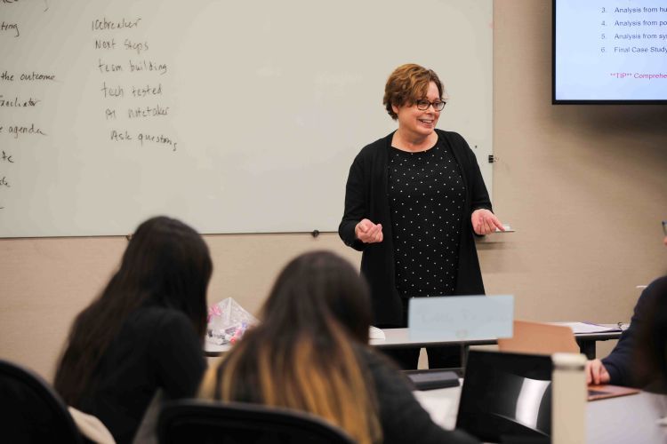 professor in front of class.