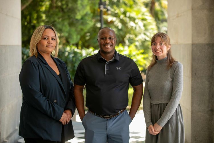 A portrait of three students outdoors