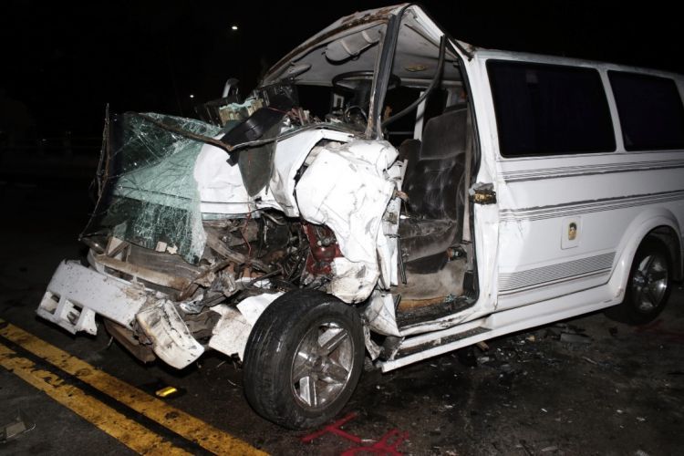 A white vehicle that has severe damage due to a crash. 