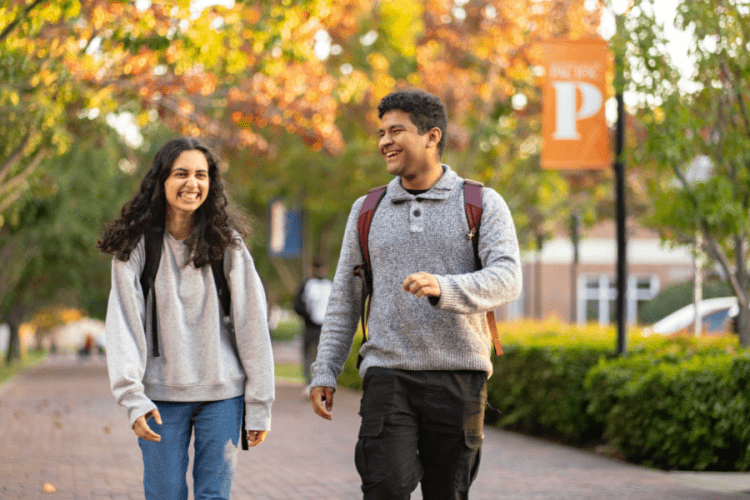 Two students walking on campus