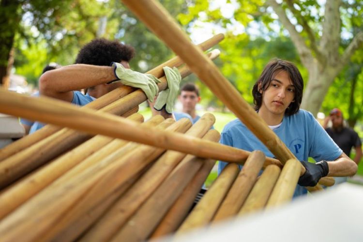 Student building a structure out of wood