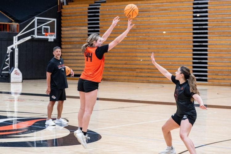 A student shoots a basketball 
