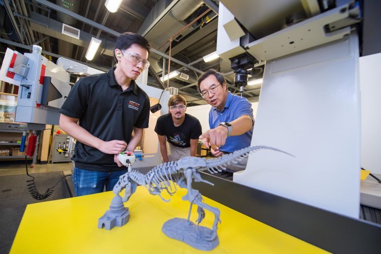 Students building dinosaur