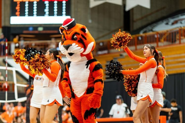 Tommy the Tiger stands with the cheer team