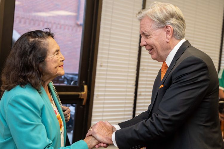 Dolores Huerta shaking President Callahan's hand