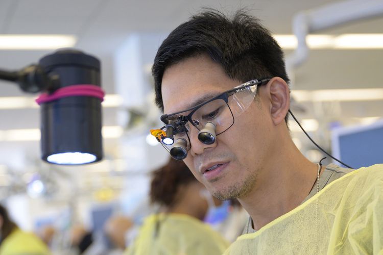 Man with special glasses for microscopic viewing
