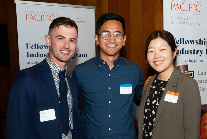 Three individuals at networking mixer