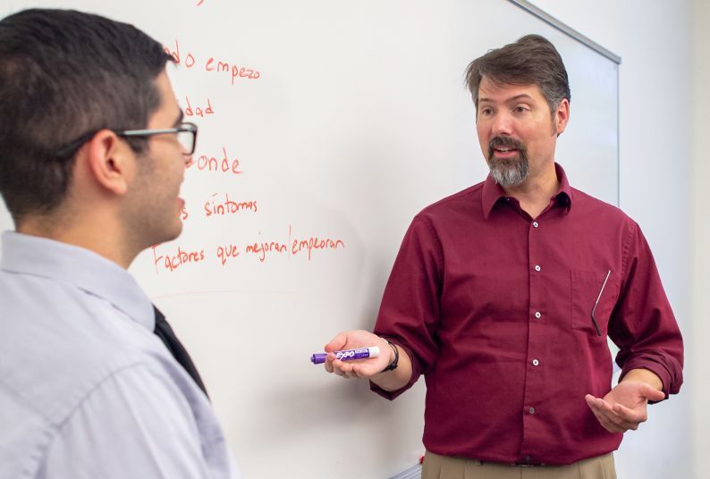 Dr. Ed Rogan with student in classroom