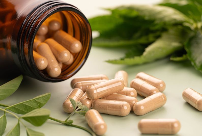 Homeopathic remedy capsules in a glass amber jar