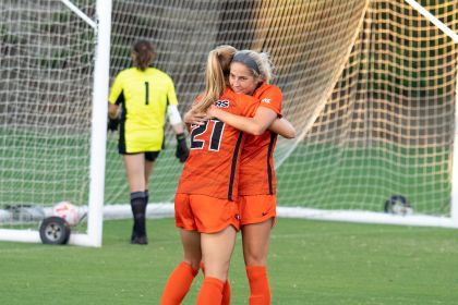 two soccer plays hug on the field
