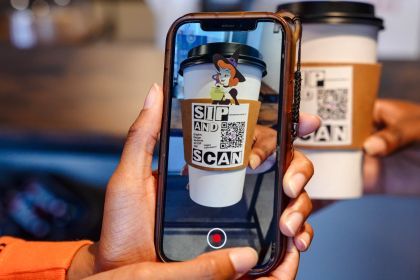 Students scan the QR code on the coffee cup to view their project.