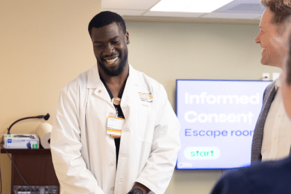 Nursing student in white lab coat.
