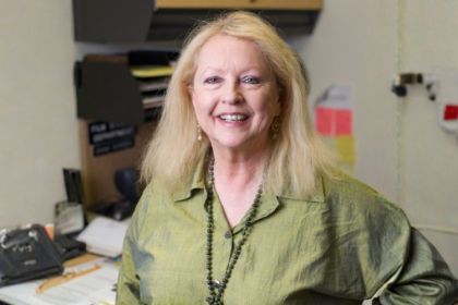 Diane Borden smiling in a classroom.