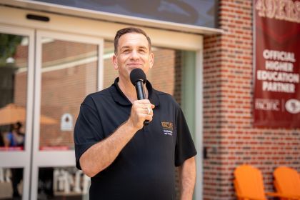 Josh O'Connor holding a microphone.