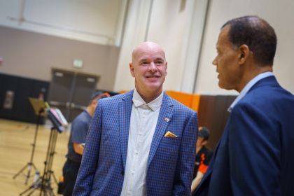 Dave Smart smiling in a blue suit.