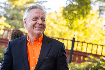 President Callahan in an orange shirt outside.
