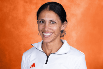 Cherise Roberts smiling with an orange backdrop.