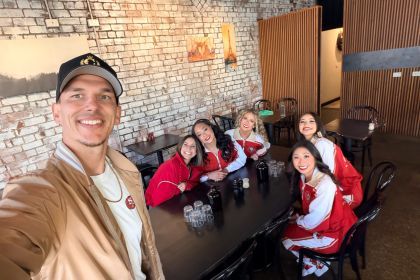 STUNT coach smiling in a selfie with the team.