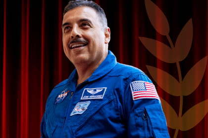 Jose smiles in a blue NASA uniform.