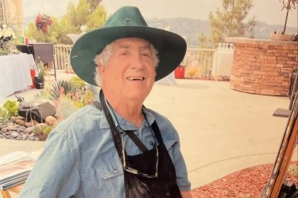 Gil Dellinger painting in front of easel with pastels.