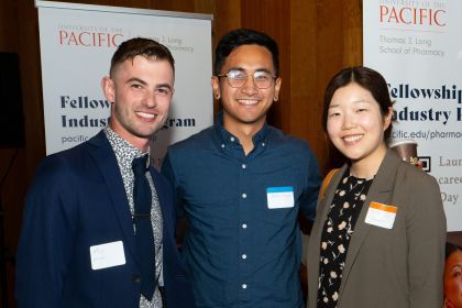 Three individuals at networking mixer