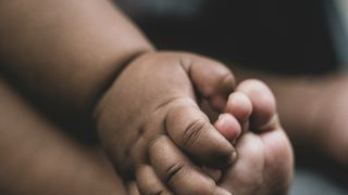 a baby's hand and foot