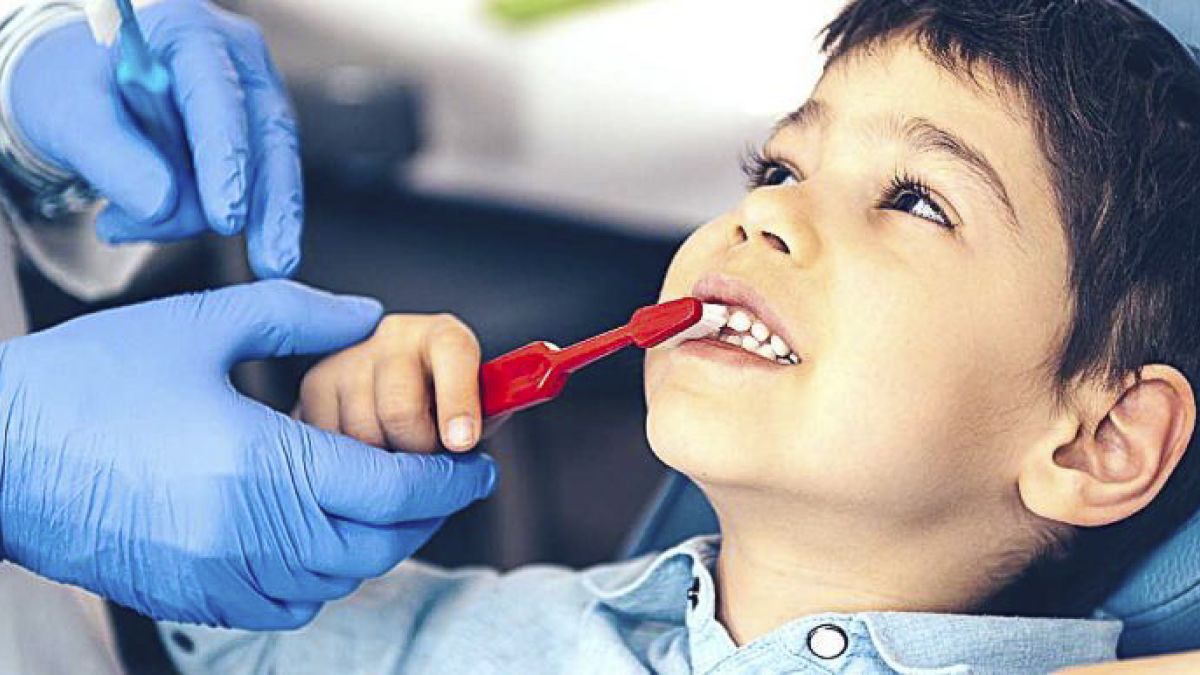 boy with red toothbrush