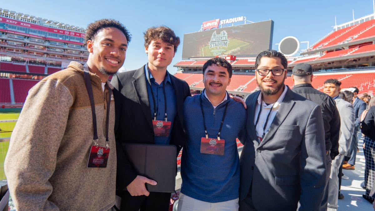 a group of students stand in a stadium
